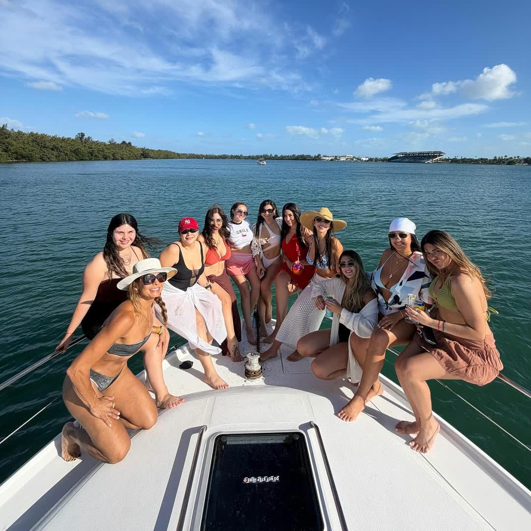 Everyone spread across the bow at the sandbar on a bright day